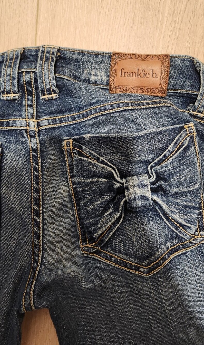 Frankie B. Distressed Blue Denim Jeans with Back Pocket Bow